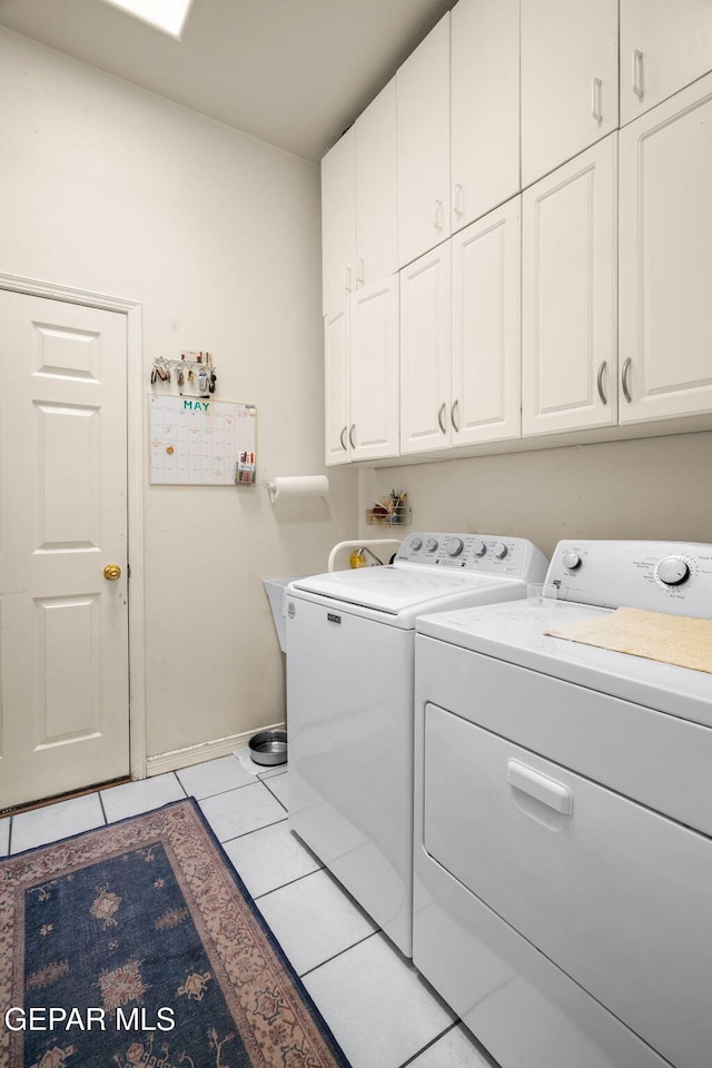 421 Wild Willow Dr, El Paso, TX 79922 - washroom featuring cabinet space, independent washer and dryer, light tile patterned flooring, and baseboards