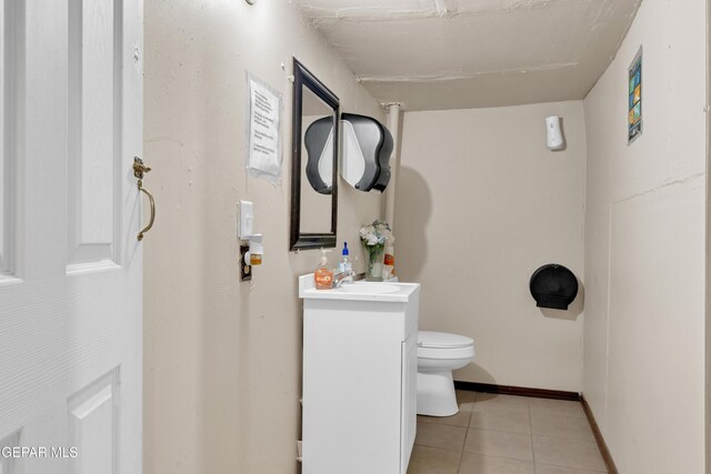8715 Lawson St, El Paso, TX 79904 - half bath featuring toilet, tile patterned floors, vanity, and baseboards