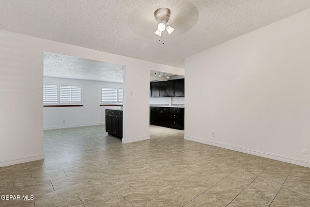 4540 Swan Dr, El Paso, TX 79922 - empty room featuring a textured ceiling, ceiling fan, and baseboards