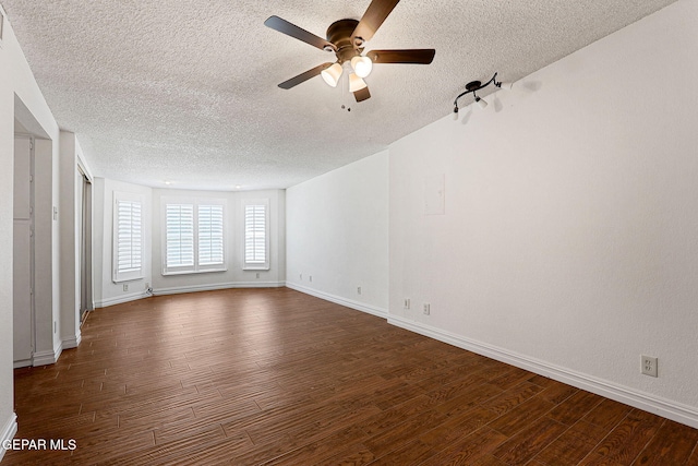 4540 Swan Dr, El Paso, TX 79922 - unfurnished room featuring a textured ceiling, dark wood-style flooring, ceiling fan, and baseboards