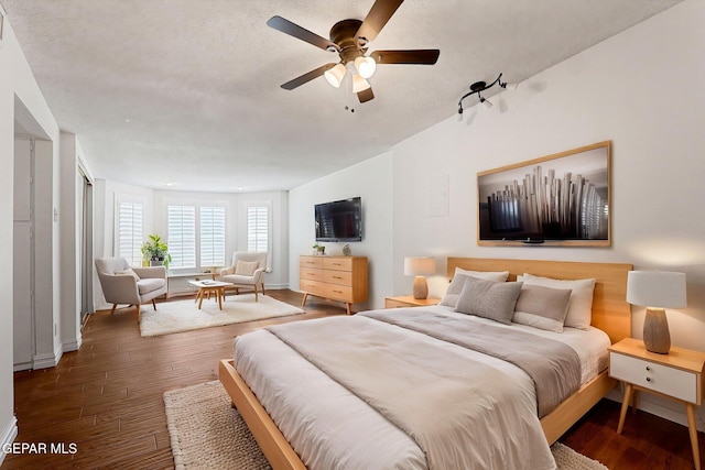 4540 Swan Dr, El Paso, TX 79922 - bedroom featuring wood finished floors, a textured ceiling, baseboards, and a ceiling fan