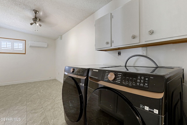 4540 Swan Dr, El Paso, TX 79922 - clothes washing area featuring cabinet space, separate washer and dryer, a textured ceiling, an AC wall unit, and baseboards