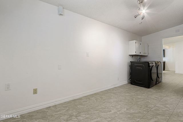 4540 Swan Dr, El Paso, TX 79922 - laundry room featuring washing machine and clothes dryer, cabinet space, a textured ceiling, and baseboards