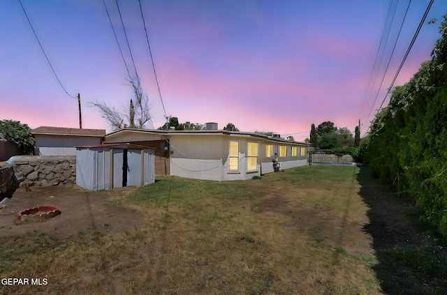4540 Swan Dr, El Paso, TX 79922 - back of property with a shed, an outdoor structure, and a yard
