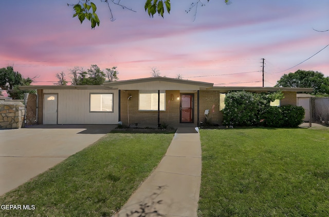 4540 Swan Dr, El Paso, TX 79922 - view of front facade with brick siding, a lawn, and concrete driveway