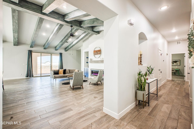 309 Blue Vly, El Paso, TX 79928 - living room featuring wood finished floors, beam ceiling, baseboards, a glass covered fireplace, and recessed lighting