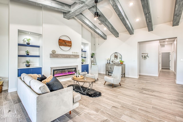 309 Blue Vly, El Paso, TX 79928 - living room with baseboards, a glass covered fireplace, wood finished floors, recessed lighting, and built in shelves