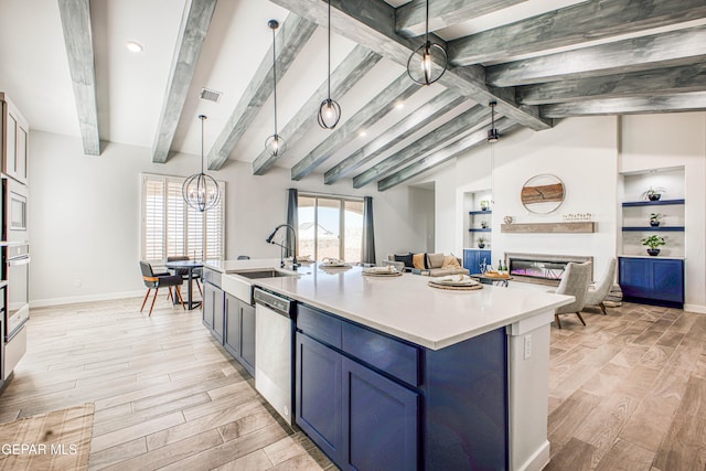 309 Blue Vly, El Paso, TX 79928 - kitchen featuring a sink, stainless steel dishwasher, blue cabinetry, open floor plan, and light wood-style flooring
