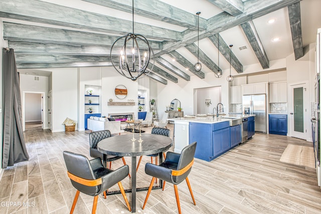 309 Blue Vly, El Paso, TX 79928 - dining room featuring a glass covered fireplace, a chandelier, light wood-type flooring, and recessed lighting