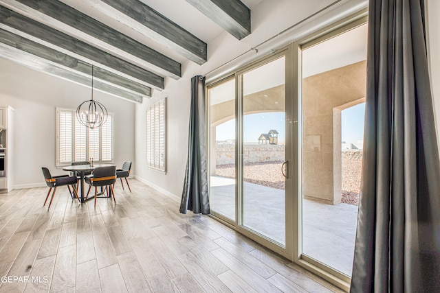 309 Blue Vly, El Paso, TX 79928 - dining area with beamed ceiling, a chandelier, light wood finished floors, and baseboards