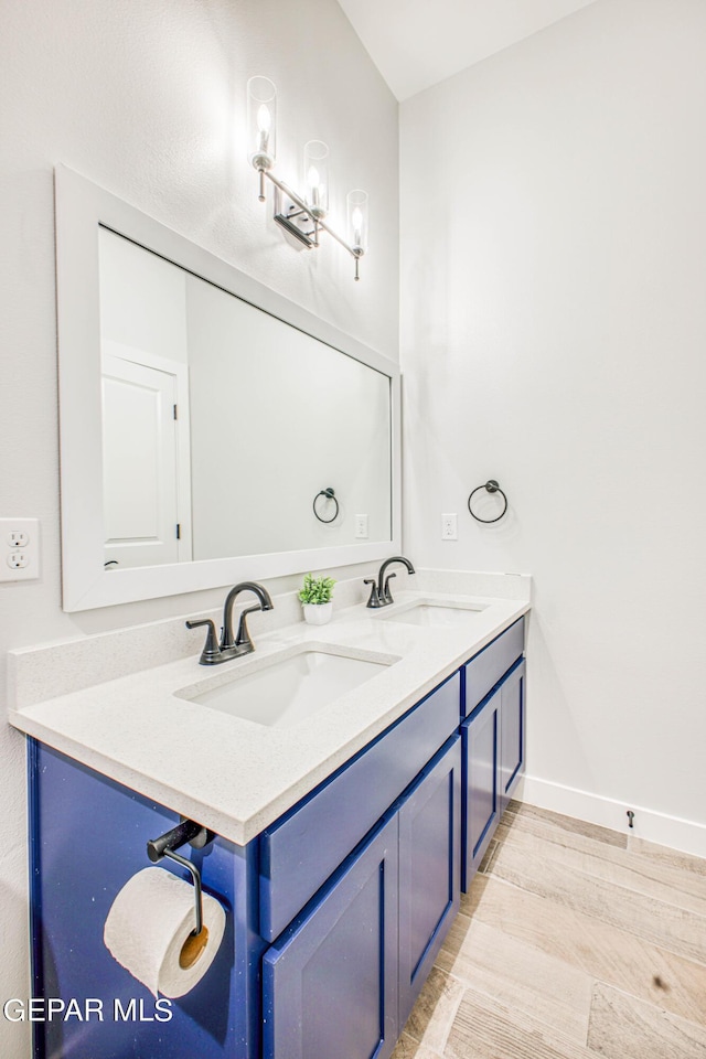 309 Blue Vly, El Paso, TX 79928 - full bathroom featuring wood finished floors, baseboards, and double vanity