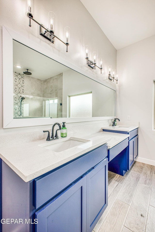 309 Blue Vly, El Paso, TX 79928 - bathroom featuring a shower stall, vanity, and wood finished floors