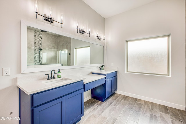 309 Blue Vly, El Paso, TX 79928 - full bathroom featuring a stall shower, double vanity, wood finished floors, and baseboards