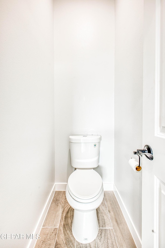 309 Blue Vly, El Paso, TX 79928 - bathroom featuring baseboards, toilet, and wood finished floors