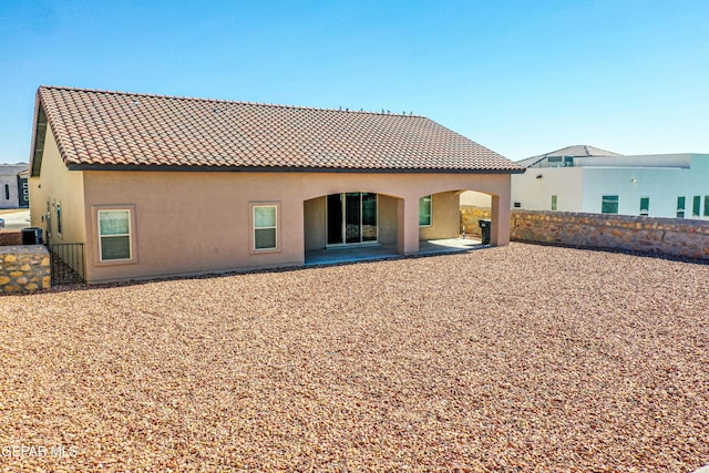 309 Blue Vly, El Paso, TX 79928 - rear view of property featuring stucco siding, a tile roof, fence, and a patio area