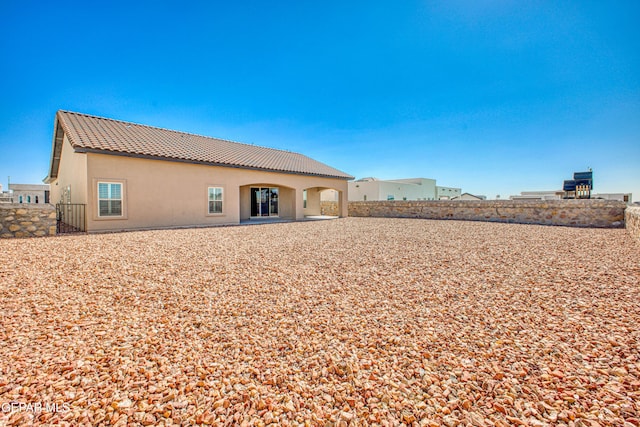 309 Blue Vly, El Paso, TX 79928 - back of property with a tile roof, fence, stucco siding, and a patio