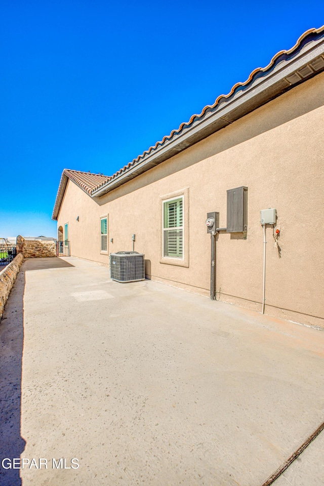 309 Blue Vly, El Paso, TX 79928 - back of property featuring stucco siding, central air condition unit, fence, a tile roof, and a patio