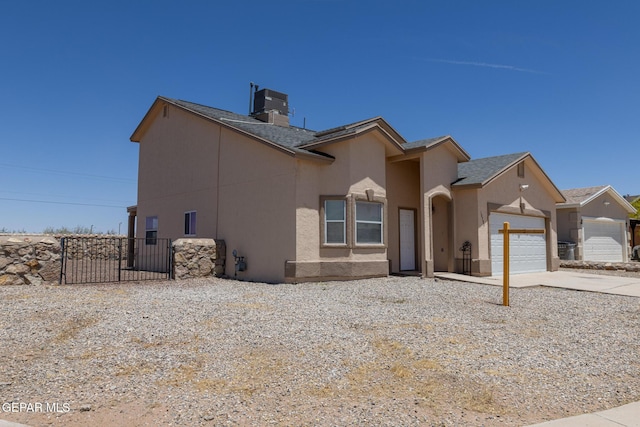 10793 Blue Sage Cir, El Paso, TX 79924 - view of front of property featuring an attached garage, concrete driveway, fence, stucco siding, and a chimney