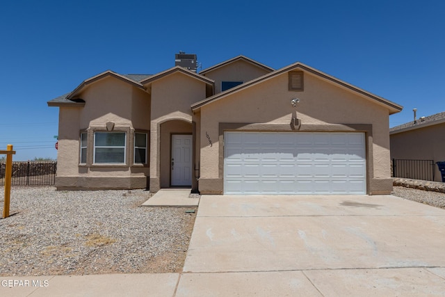 10793 Blue Sage Cir, El Paso, TX 79924 - view of front of home featuring stucco siding, driveway, fence, an attached garage, and central AC