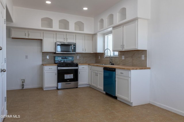 10793 Blue Sage Cir, El Paso, TX 79924 - kitchen featuring appliances with stainless steel finishes, a sink, light countertops, tasteful backsplash, and white cabinets