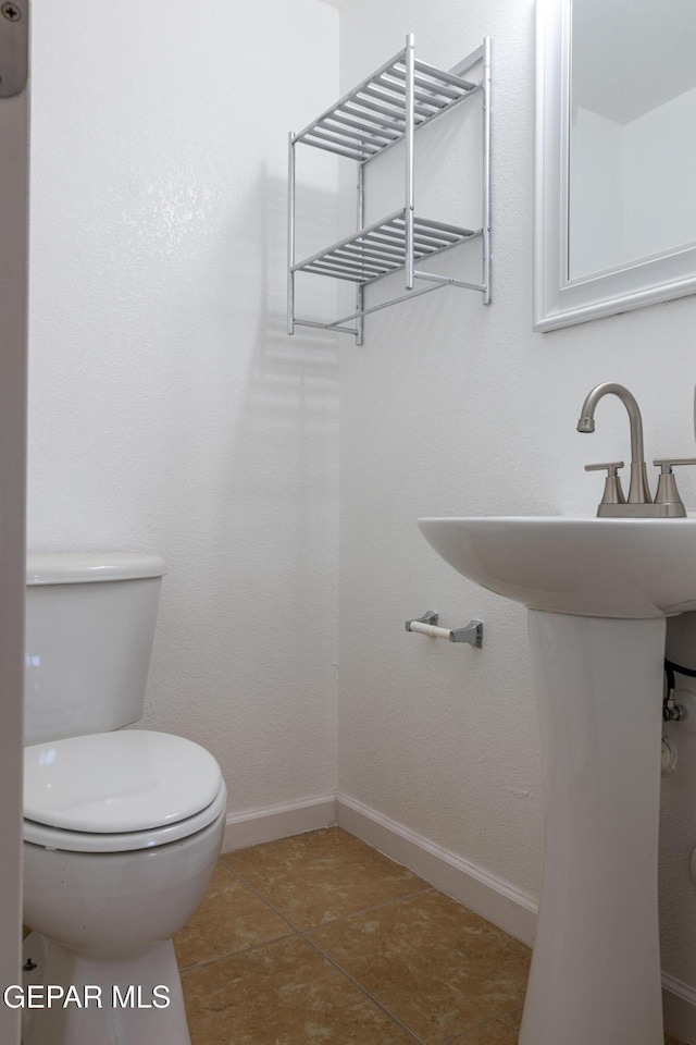 10793 Blue Sage Cir, El Paso, TX 79924 - half bath featuring toilet, baseboards, and tile patterned floors