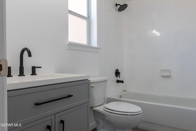 10793 Blue Sage Cir, El Paso, TX 79924 - bathroom with toilet, vanity, shower / bathtub combination, and a textured wall