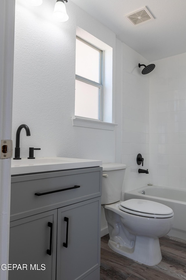 10793 Blue Sage Cir, El Paso, TX 79924 - full bath featuring wood finished floors, toilet, vanity, and washtub / shower combination