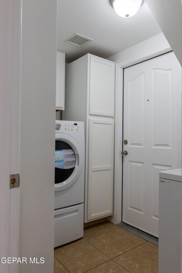 10793 Blue Sage Cir, El Paso, TX 79924 - laundry room featuring cabinet space, washer / clothes dryer, and light tile patterned floors