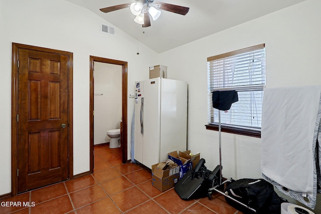 613 Willow Glen Dr, El Paso, TX 79922 - kitchen featuring vaulted ceiling, freestanding refrigerator, a ceiling fan, and dark tile patterned flooring