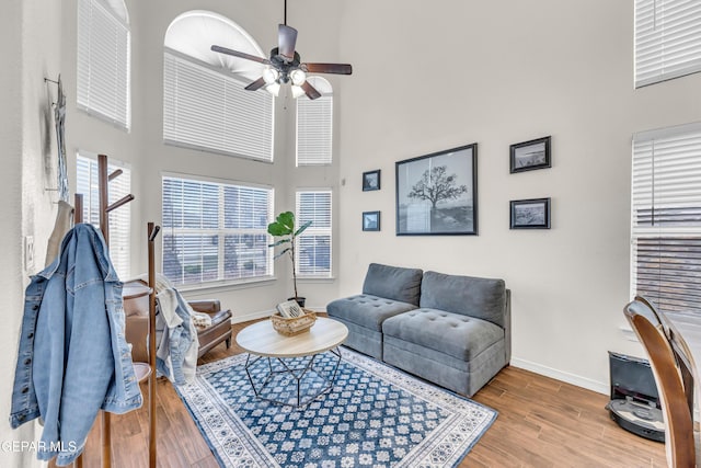 3208 Cascade Point Dr, El Paso, TX 79938 - living area featuring baseboards, a ceiling fan, a towering ceiling, and wood finished floors