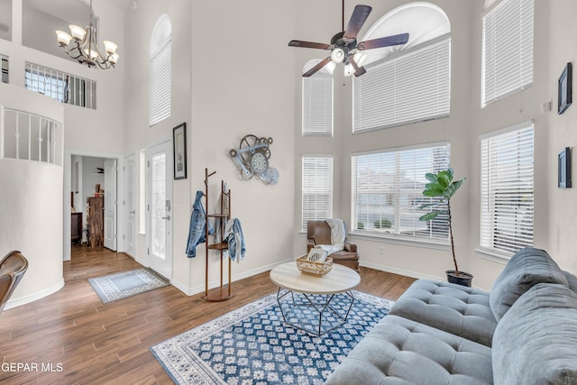 3208 Cascade Point Dr, El Paso, TX 79938 - living area with a high ceiling, healthy amount of natural light, a chandelier, ceiling fan, and wood finished floors
