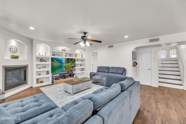 3208 Cascade Point Dr, El Paso, TX 79938 - living area with a glass covered fireplace, ceiling fan, stairway, dark wood-type flooring, and recessed lighting