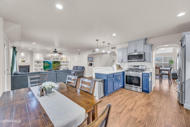 3208 Cascade Point Dr, El Paso, TX 79938 - dining space featuring arched walkways, ceiling fan, recessed lighting, and light wood-type flooring
