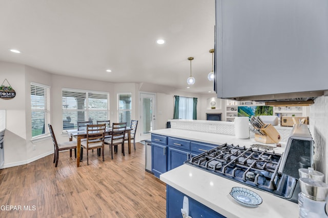 3208 Cascade Point Dr, El Paso, TX 79938 - kitchen featuring blue cabinetry, recessed lighting, light countertops, light wood-style flooring, and a peninsula