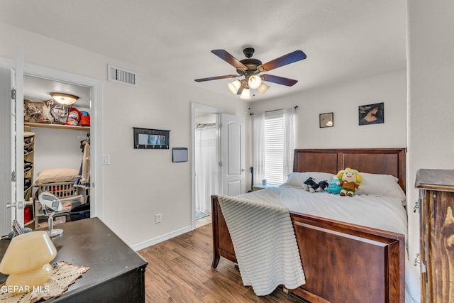 3208 Cascade Point Dr, El Paso, TX 79938 - bedroom featuring a walk in closet, wood finished floors, baseboards, a closet, and a ceiling fan