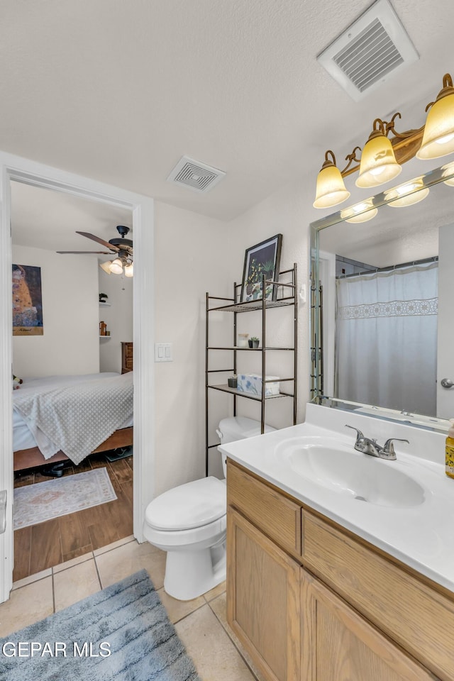 3208 Cascade Point Dr, El Paso, TX 79938 - bathroom with connected bathroom, tile patterned floors, vanity, toilet, and ceiling fan
