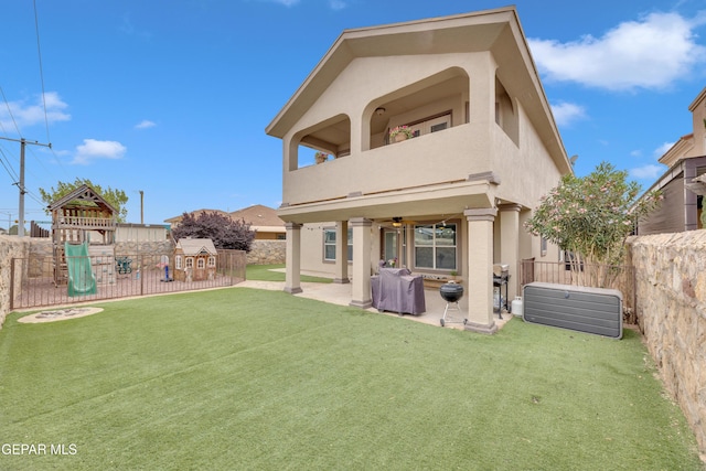 3208 Cascade Point Dr, El Paso, TX 79938 - back of house featuring a balcony, stucco siding, a playground, a patio, and a ceiling fan