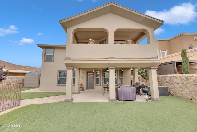 3208 Cascade Point Dr, El Paso, TX 79938 - rear view of property with a balcony, stucco siding, a patio area, a ceiling fan, and a storage unit