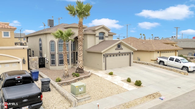 3208 Cascade Point Dr, El Paso, TX 79938 - view of front of house featuring a garage, stucco siding, driveway, and cooling unit