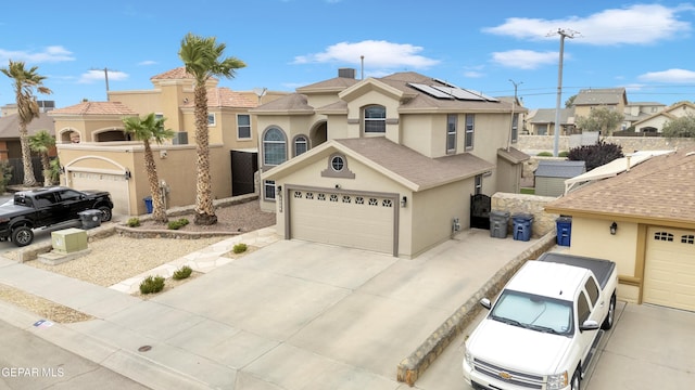 3208 Cascade Point Dr, El Paso, TX 79938 - view of front of home with stucco siding, solar panels, concrete driveway, a garage, and a residential view