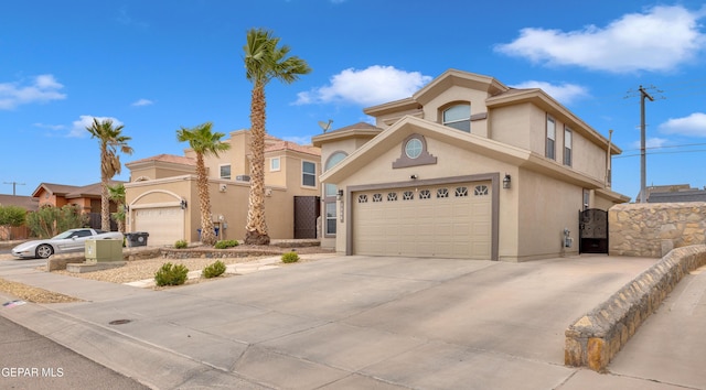3208 Cascade Point Dr, El Paso, TX 79938 - view of front of property with stucco siding, driveway, a garage, and a gate