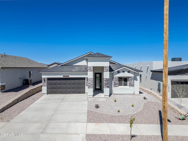 3801 Course St, El Paso, TX 79938 - view of front of home with an attached garage, driveway, stucco siding, stone siding, and central air condition unit