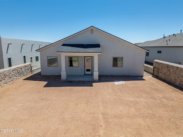 3801 Course St, El Paso, TX 79938 - rear view of house with a fenced backyard, stucco siding, a patio, and a shingled roof