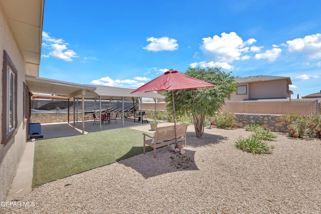 fenced backyard with a patio area