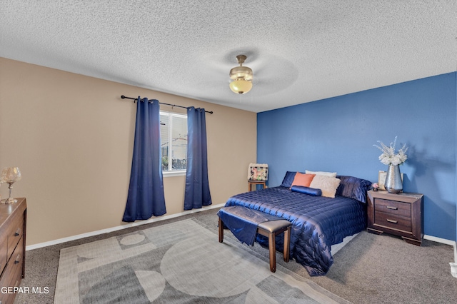 carpeted bedroom featuring baseboards, a textured ceiling, and ceiling fan