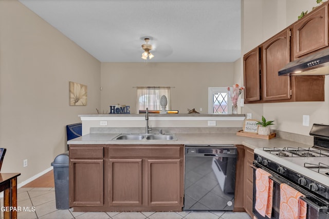 kitchen with black dishwasher, gas stove, a sink, a peninsula, and light countertops