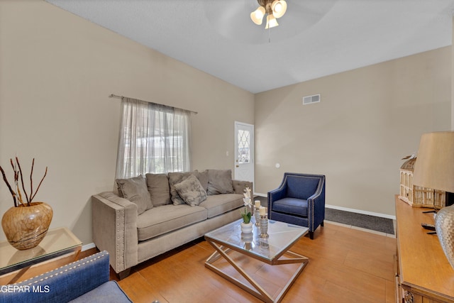 living area with ceiling fan, wood finished floors, and baseboards