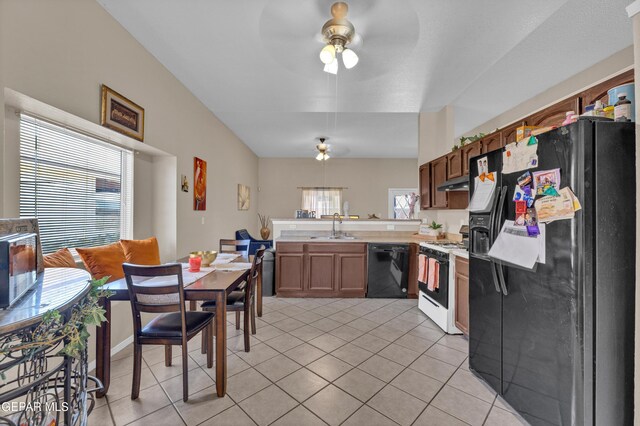 kitchen with black appliances, a peninsula, a sink, and light tile patterned floors