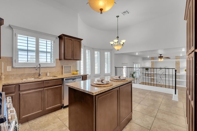 3165 Diego Aidan Dr, El Paso, TX 79938 - kitchen with a sink, appliances with stainless steel finishes, a chandelier, light tile patterned floors, and a towering ceiling