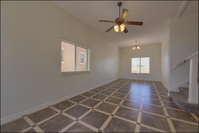 empty room featuring stairs, vaulted ceiling, a ceiling fan, baseboards, and a chandelier